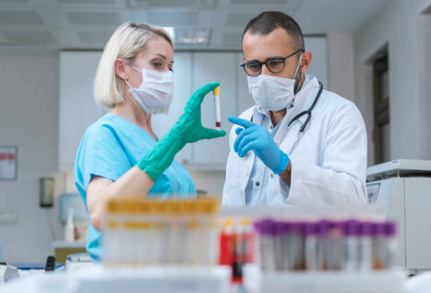 A male and female doctor in a lab show blood infection and take homeopathic treatment at Santosh Homoeo Hall and Clinic